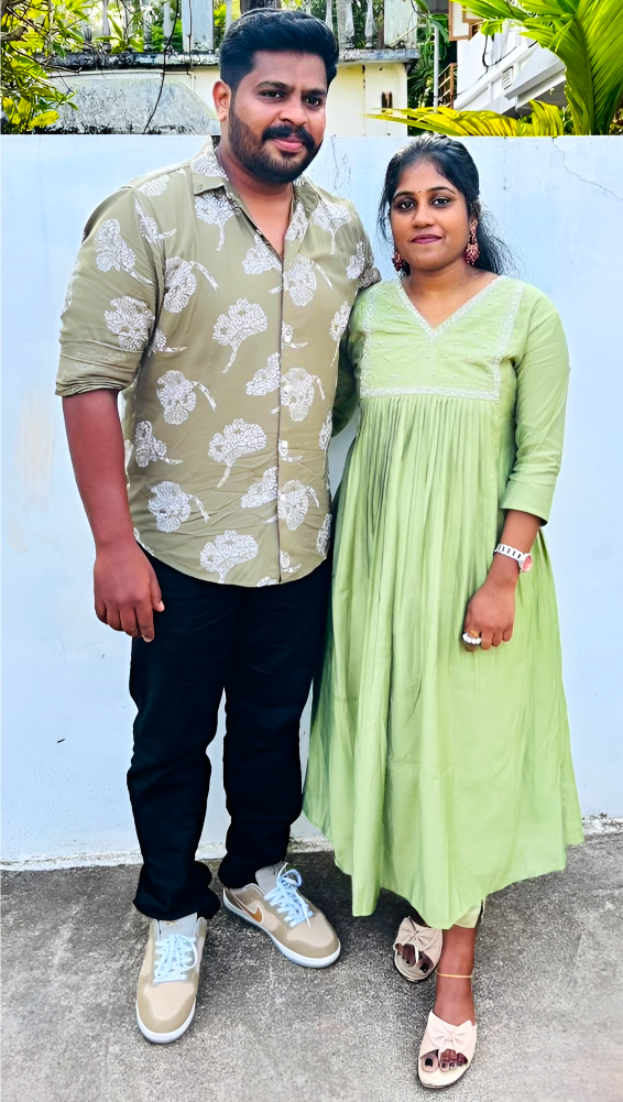 Sajith And Jereena Wearing Green, Standing Outdoors